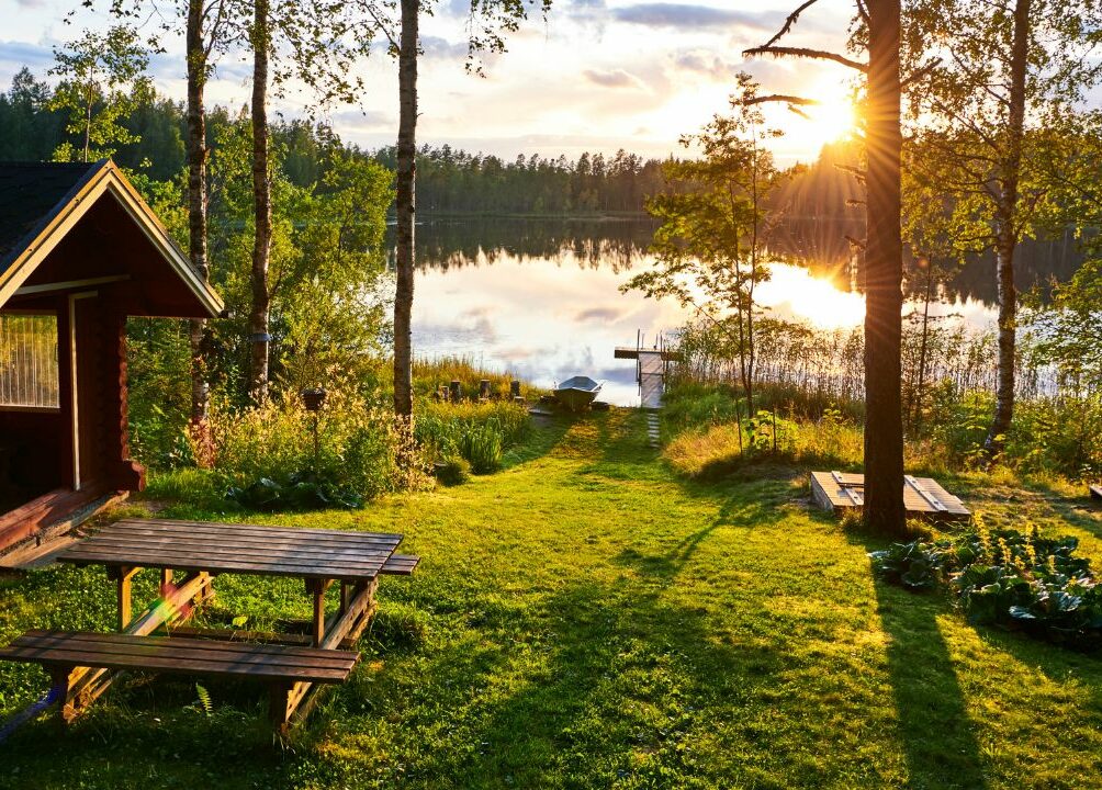 Tiny home in nature setting, sunset over a lake and forest