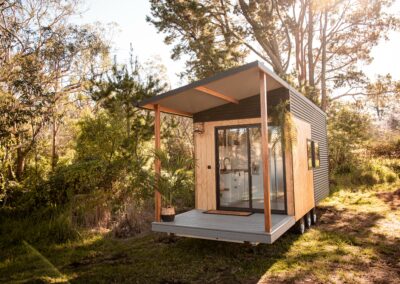 Single level tiny home with deck and awning.