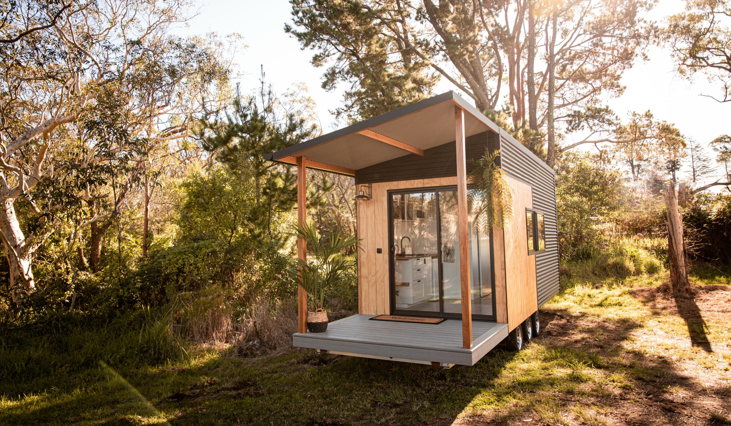 Single level tiny home with deck and awning.
