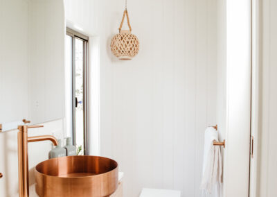 Minimalist Tiny Home bathroom with copper details and LED Mirror